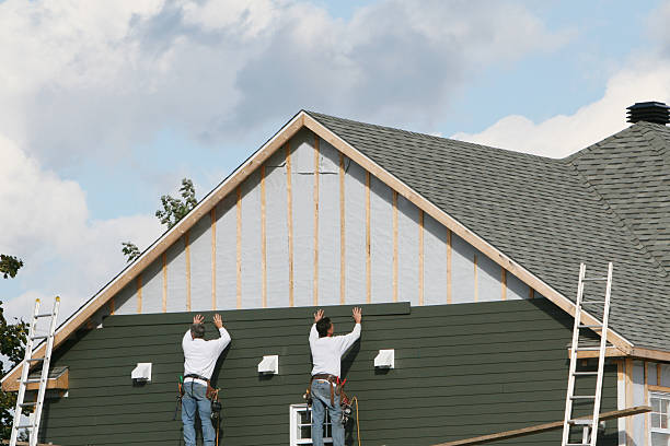 Professional Storm Damage Siding Repair technician working in Uhrichsville, OH